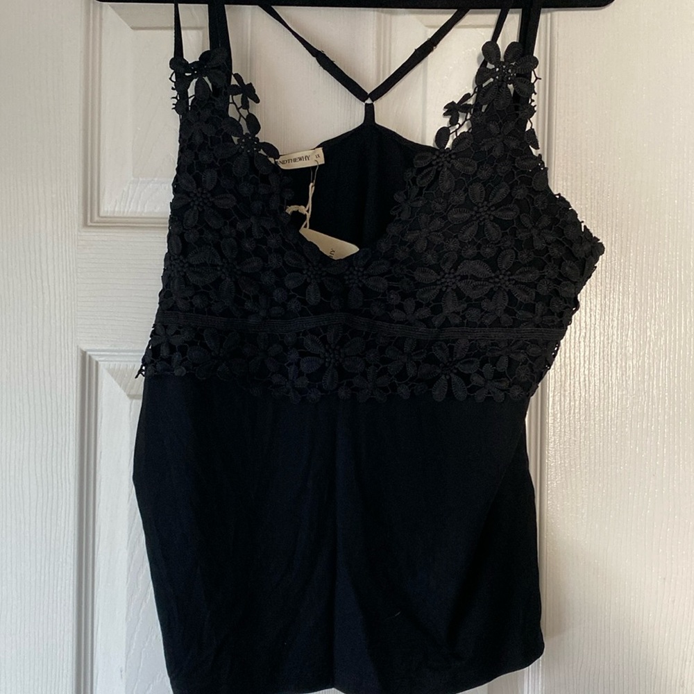 Black bralette with adjustable straps. Very cute flowered details on the front
